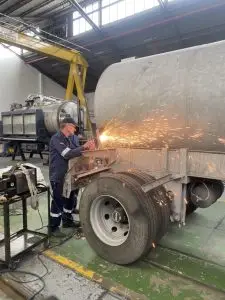 Cutting all the rusted parts off the vacuum truck